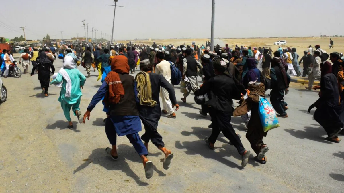 People rush towards a border crossing point in Pakistan's border town of Chaman, on July 17, 2021. (Banaras Khan/AFP via Getty Images)