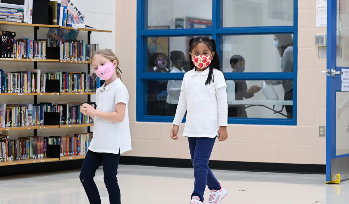 Children arrive in line using physical distancing before getting their picture taken at picture day at St. Barnabas Catholic School during the COVID-19 pandemic in Scarborough, Ont., on Oct. 27, 2020. (THE CANADIAN PRESS/Nathan Denette)