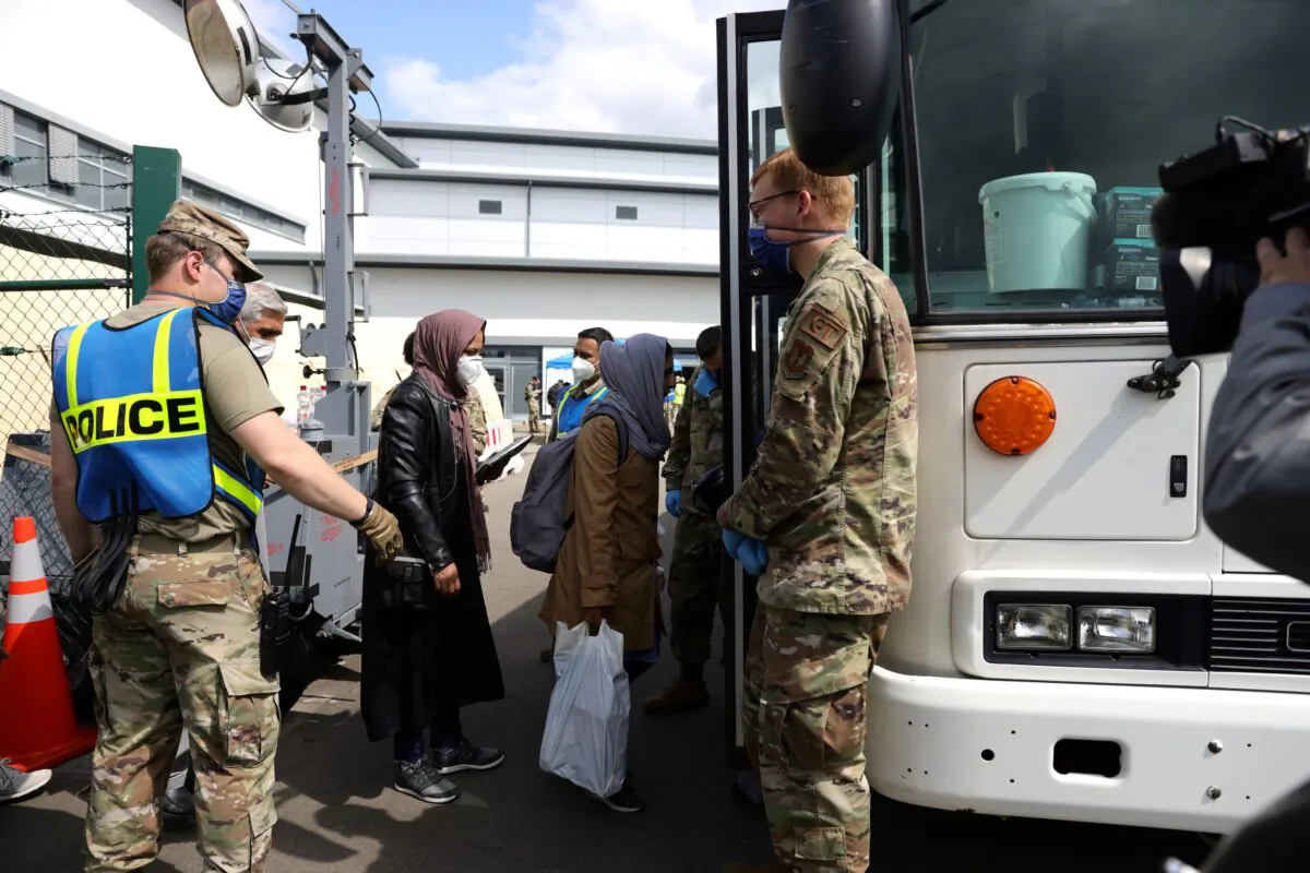 Evacuees from Afghanistan walk from a temporary tent to a bus at Ramstein Air Base in Ramstein-Miesenbach, Germany, on Aug. 26, 2021. (Andreas Rentz/Getty Images)