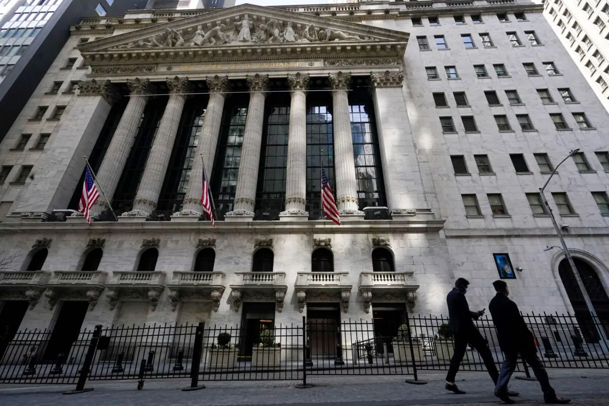 Pedestrians walk past the New York Stock Exchange in New York's Financial District on March 23, 2021. (Mary Altaffer/File/AP Photo)