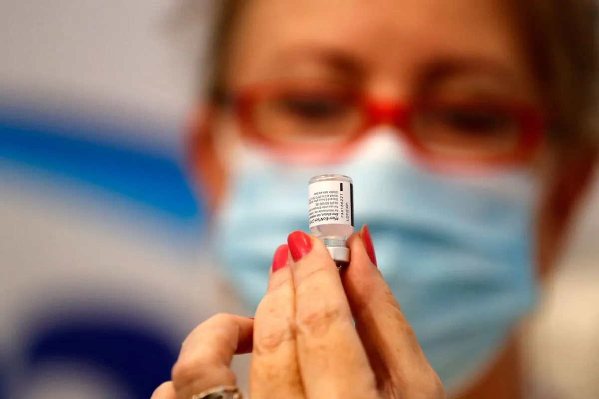 An Israeli health worker prepares a dose of the Pfizer–BioNtech COVID-19 vaccine, at the Maccabi Health Service in the Israeli town of Rishon Lezion, on Aug. 13, 2021. (Ahmad Gharabli/AFP via Getty Images)