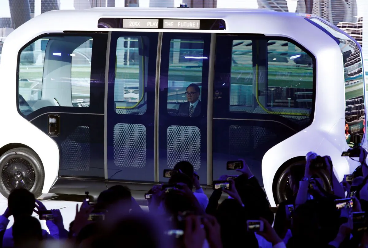 Toyota Motor Corporation President Akio Toyoda, arrives in their e-Palette autonomous concept vehicle to give his presentation at the Tokyo Motor Show, in Tokyo, Japan, on Oct. 23, 2019. (Edgar Su/File/Reuters)