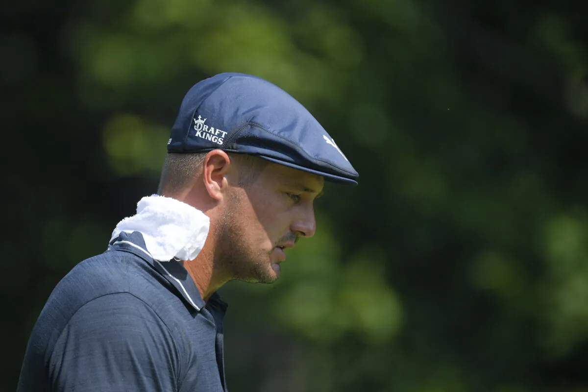 Bryson DeChambeau wears a towel on his neck during high temperatures at the BMW Championship golf tournament in Caves Valley Golf Club in Owings Mills, Md.on Aug. 27, 2021. (AP Photo/Nick Wass)