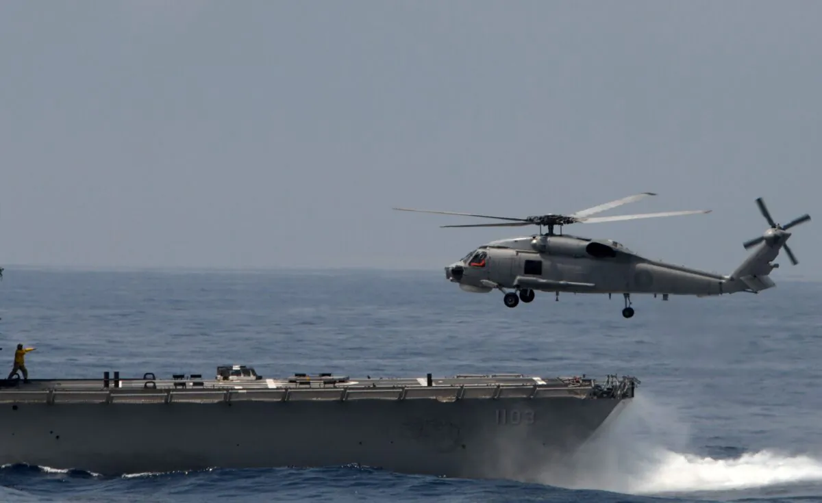 A U.S.-made S70C helicopter is guided by a navy soldier during take off from a frigate at the sea near the Suao navy harbour in Yilan, eastern Taiwan on April 13, 2018. (Sam Yeh/AFP via Getty Images)