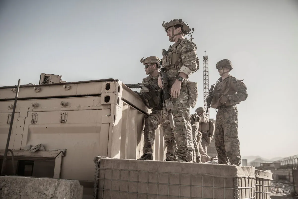 U.S. service members assist at an Evacuation Control Check Point (ECC) during an evacuation at Hamid Karzai International Airport, Kabul, Afghanistan, on Aug. 26, 2021. (Staff Sgt. Victor Mancilla/U.S. Marine Corps/Handout via Reuters)
