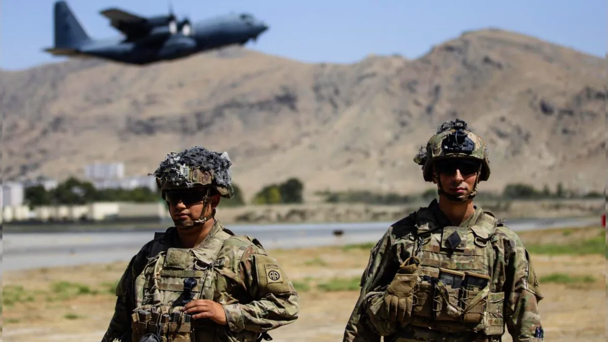 Two paratroopers assigned to the 1st Brigade Combat Team, 82nd Airborne Division conduct security while a C-130 Hercules takes off during a evacuation operation in Kabul, Afghanistan on Aug. 25, 2021. (Department of Defense via AP)