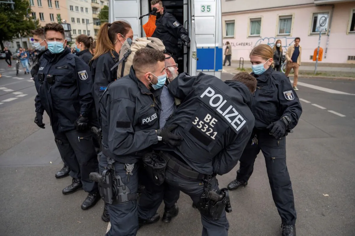 Police restrain a demonstrator, during a protest against coronavirus restrictions, in Berlin, on Aug. 28, 2021. (Christophe Gateau/dpa via AP)