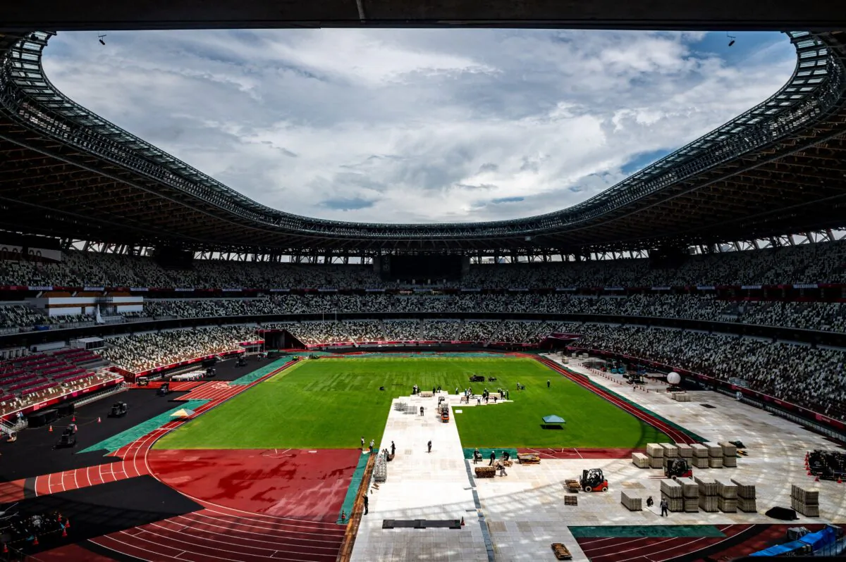 This general view shows the Olympic Stadium as staff members clear up in Tokyo on Aug. 9, 2021, the morning after the closing ceremony for the 2020 Tokyo Olympic Games. (Philip Fong/AFP via Getty Images)