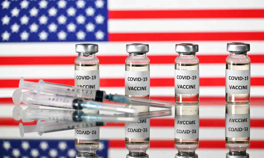 An illustration picture of COVID-19 vaccine vials with a flag of the United States. (Justin Tallis/AFP via Getty Images)