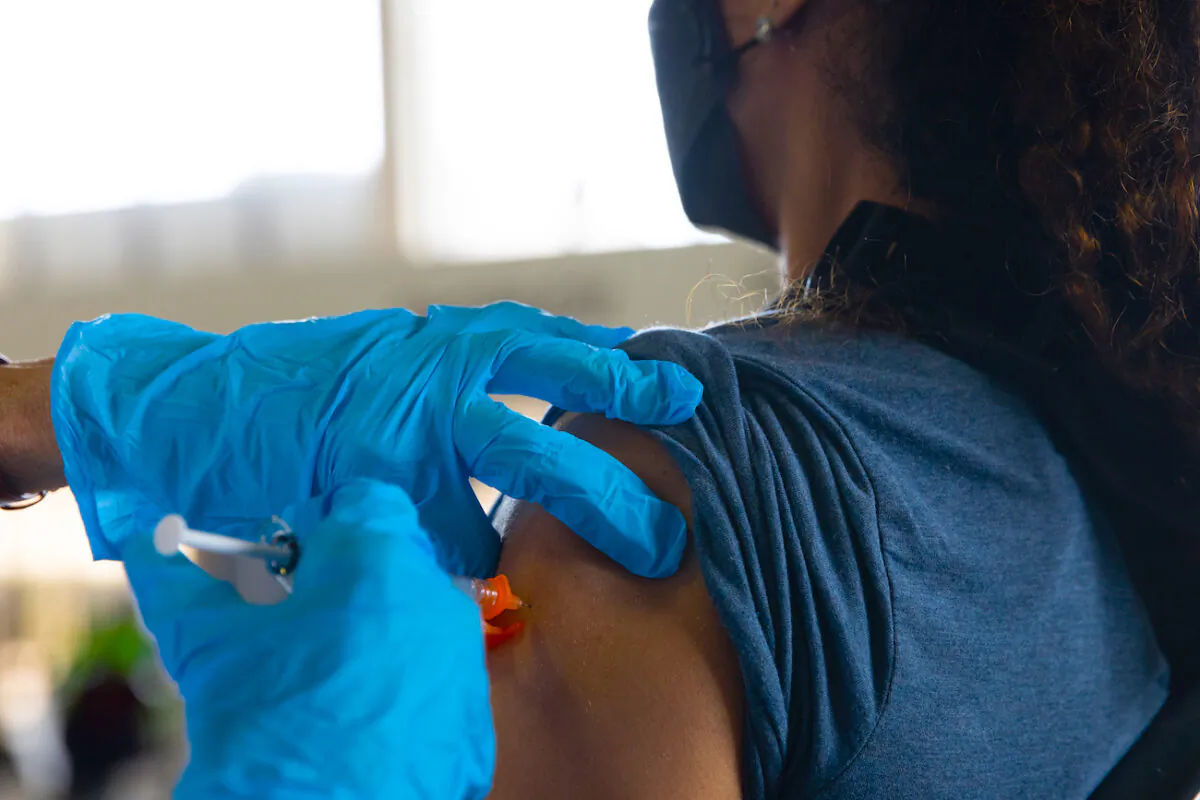 A patient receives her booster dose of the Pfizer-BioNTech COVID-19 vaccine at the Southfield Pavilion in Southfield, Mich., on Aug. 24, 2021. (Emily Elconin/Getty Images)