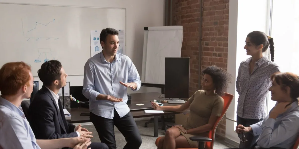 Co-workers socializing in the office. (Shutterstock)