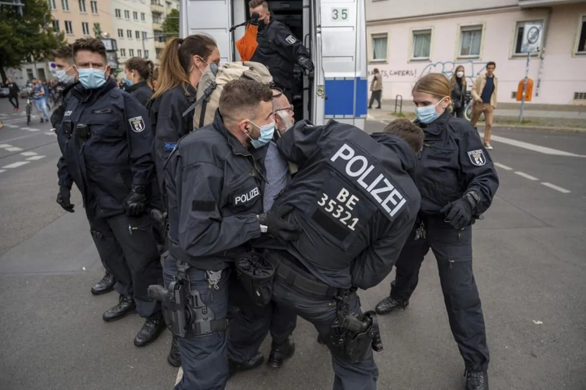 Police restrain a demonstrator during a protest against coronavirus restrictions in Berlin, Aug. 28, 2021. (Christophe Gateau/dpa via AP)