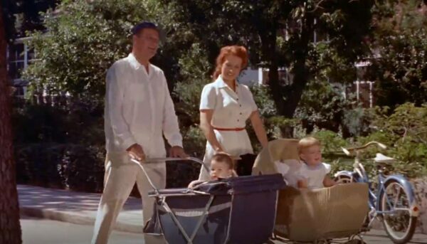 mom and dad with babes in strollers
