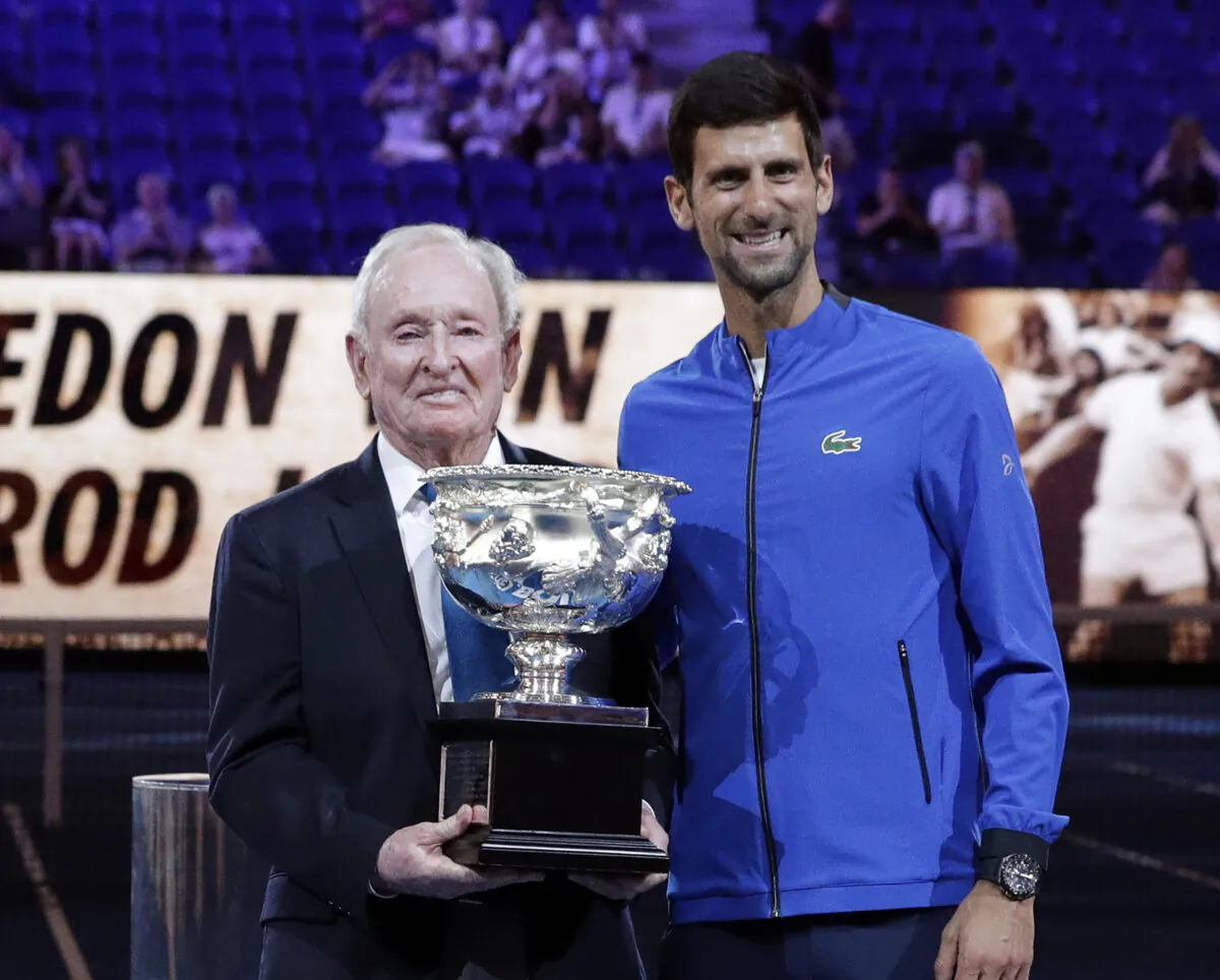 Serbia's Novak Djokovic (R), presents a trophy to Rod Laver during the 50th anniversary celebration for the Australian Open and Laver's second Grand Slam at the Australian Open tennis championships in Melbourne, Australia on Jan. 14, 2019. (Aaron Favila/AP Photo)