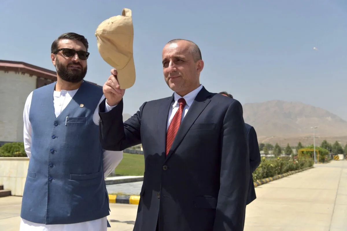 Then-Vice President of Afghanistan Amrullah Saleh (R) gestures as he stands along with National Security Adviser of Afghanistan Hamdullah Mohib prior to a meeting at the Afghan Parliament house in Kabul on Aug. 2, 2021. (Wakil Kohsar/AFP via Getty Images)