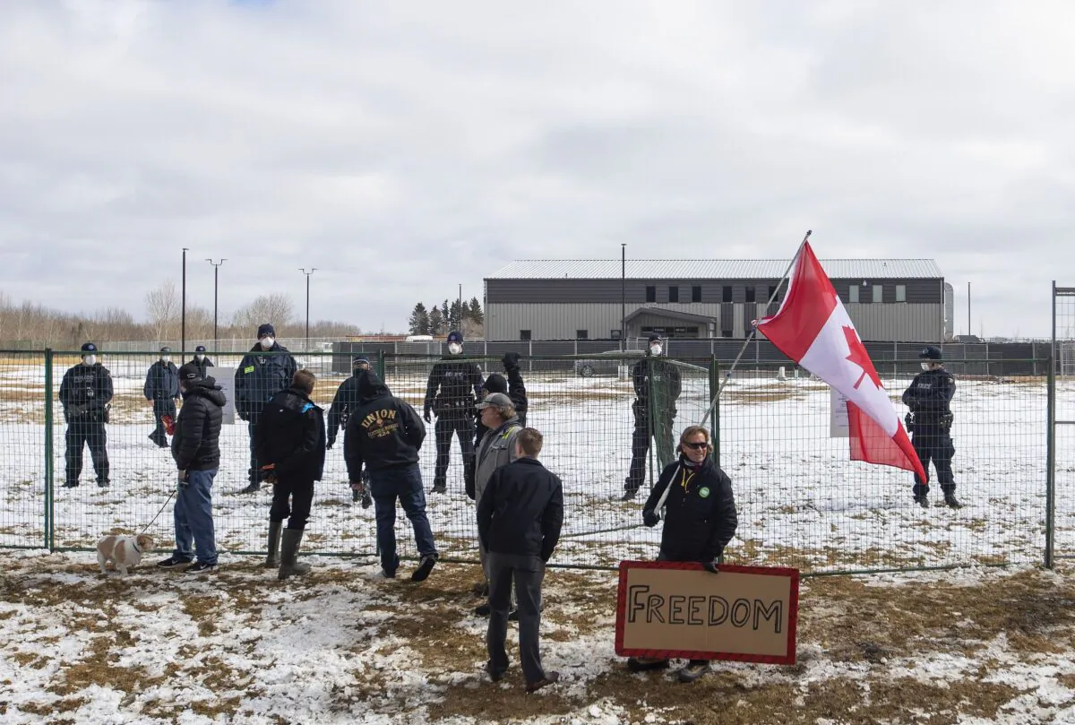 Supporters gather outside GraceLife Church near Edmonton on April 11, 2021, after the church was fenced off by police and Alberta Health Services for violating COVID-19 restrictions. (The Canadian Press/Jason Franson)