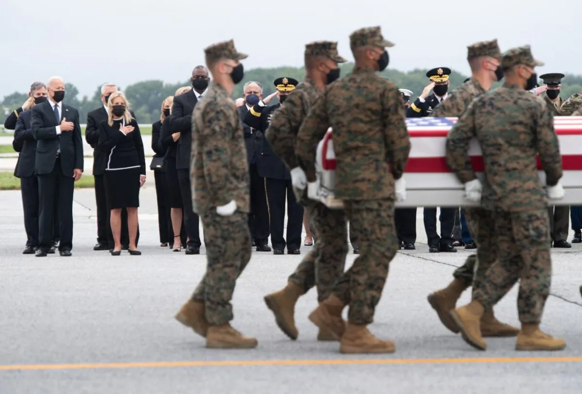 President Joe Biden, First Lady Jill Biden, Secretary of Defense Lloyd Austin, and other officials attend the dignified transfer of the remains at Dover Air Force Base in Dover, Del., on Aug. 29, 2021. (Saul Loeb/AFP via Getty Images)