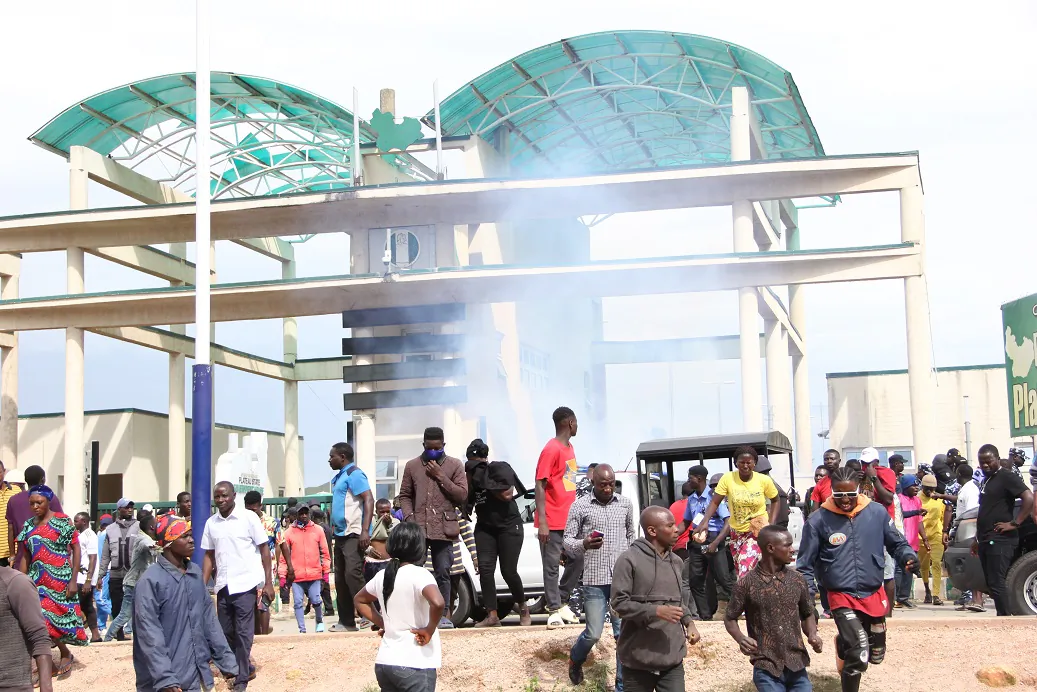 Police fire teargas to disperse protesters at the Government House in Jos, Nigeria, on Aug. 25, 2021. (Masara Kim/The Epoch Times)