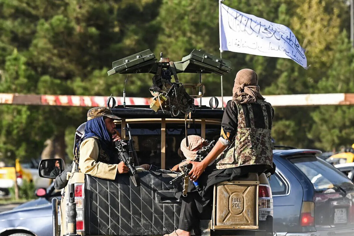 Taliban fighters in a vehicle patrol a street in Kabul on August 27, 2021, as last-ditch evacuation flights took off from Kabul airport on August 27, a day after twin suicide bombings on crowds trying to flee Taliban-controlled Afghanistan killed at least 85 people, including 13 US servicemen. (Photo by Aamir QURESHI / AFP) (Photo by AAMIR QURESHI/AFP via Getty Images)