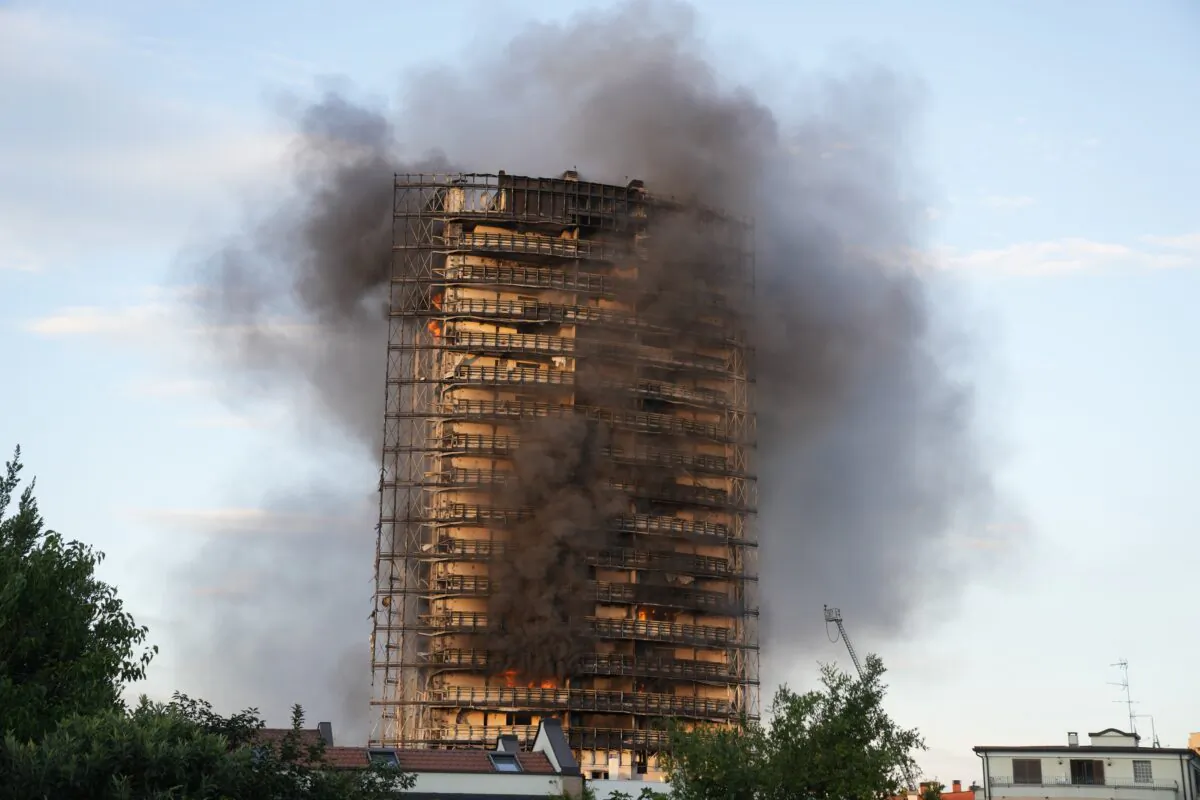 Smoke billows from a building in Milan, Italy, on Aug. 29, 2021. (Luca Bruno/AP Photo)