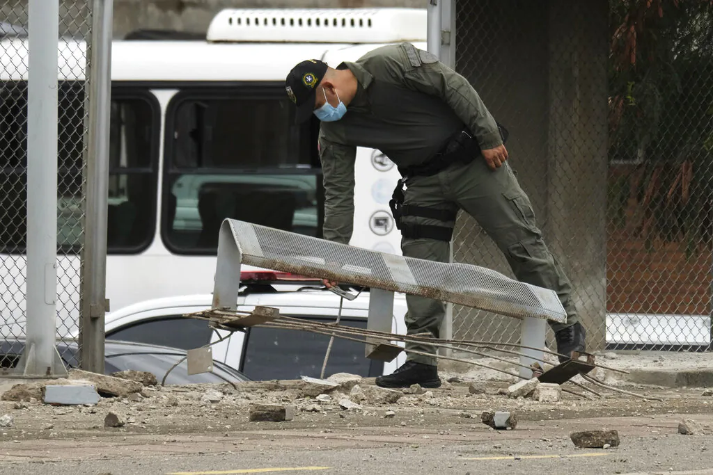 A police officer inspects damage at a police station after a bomb exploded in Cucuta, Colombia, near the Venezuelan border, on Aug. 30, 2021. (Ferley Ospina/AP Photo)
