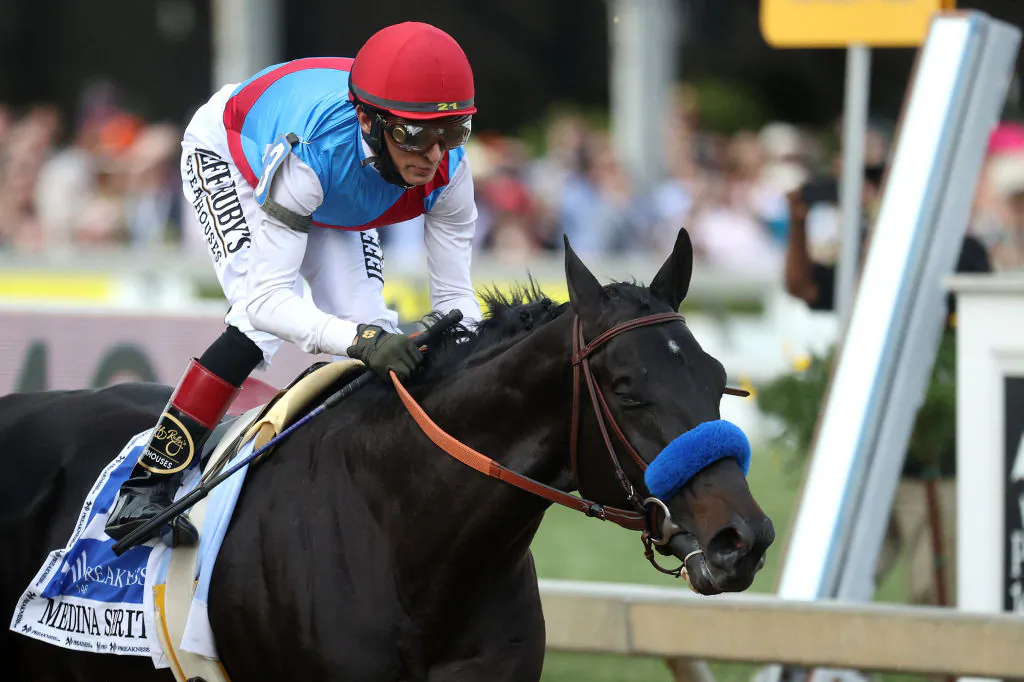 In this file photo, Jockey John Velazquez rides Medina Spirit #3 into the first turn the 146th Preakness Stakes at Pimlico Race Course in Baltimore, Maryland on May 15, 2021. (Rob Carr/Getty Images)