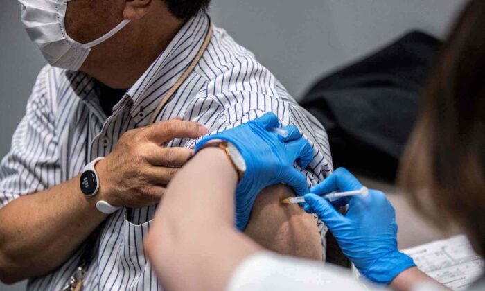 An employee of Japan's Mori Building Company, a property management firm, receives the Moderna COVID-19 vaccine in Tokyo on June 21, 2021. (Behrouz Mehri/AFP via Getty Images)