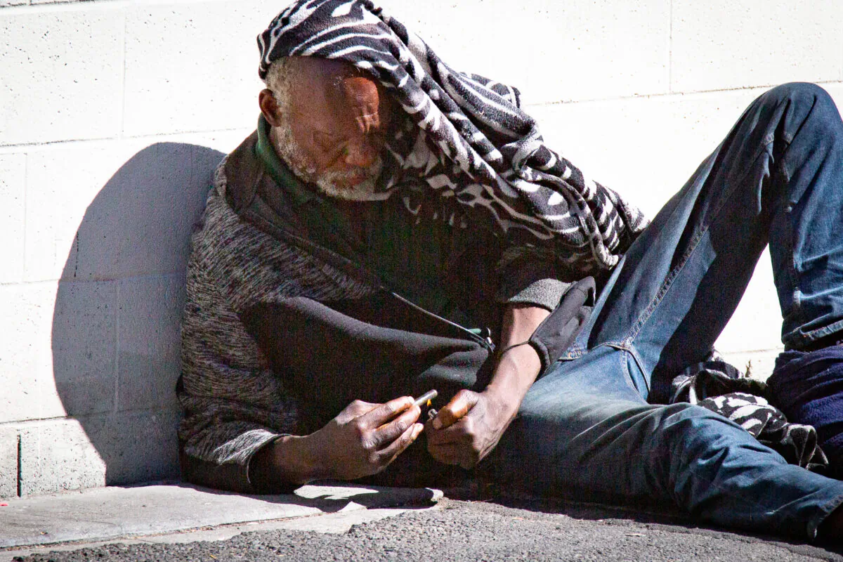 A man used drugs in Los Angeles, Calif., on June 9, 2021. (John Fredricks/The Epoch Times)
