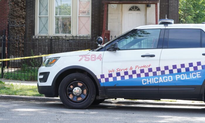 A Chicago police squad car at a shooting scene in East Garfield Park neighborhood where three people were shot half an hour earlier on Aug. 20, 2021. (Cara Ding/The Epoch Times)