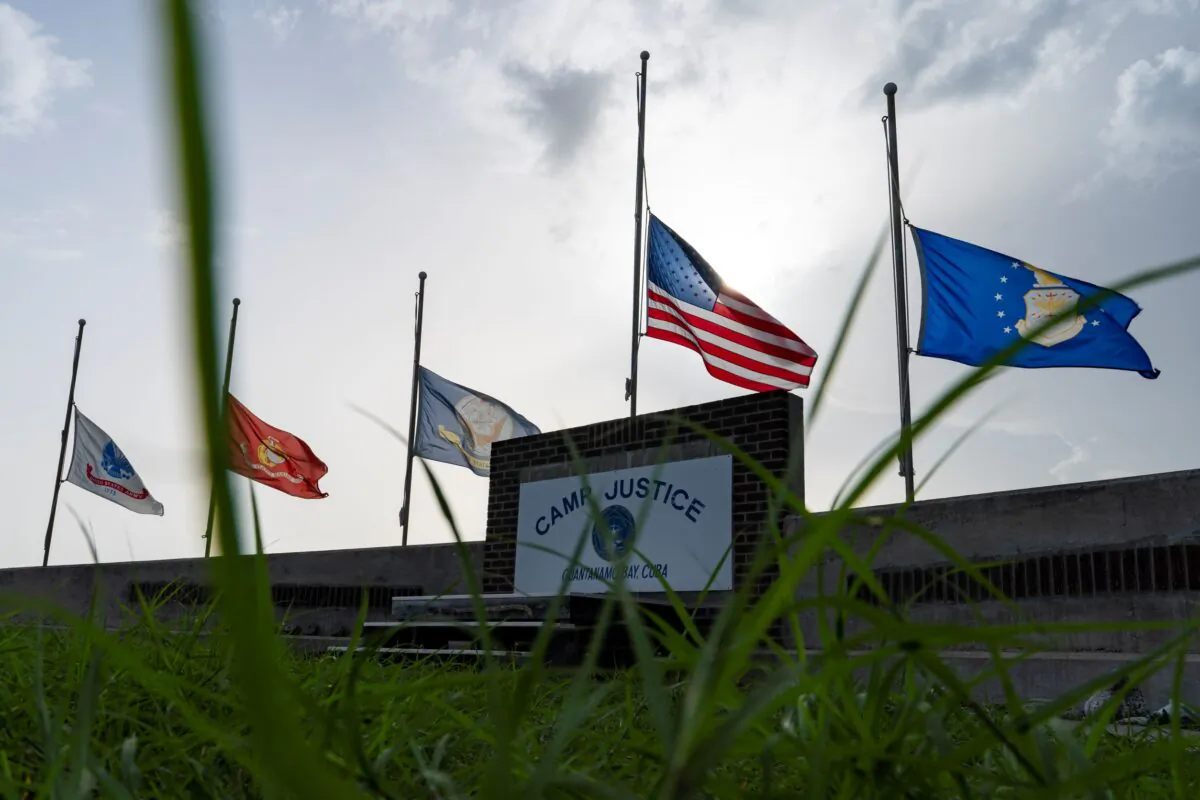 Flags fly at half-staff in honor of the U.S. service members and other victims killed in the terrorist attack in Kabul, Afghanistan, at Camp Justice, in Guantanamo Bay Naval Base, Cuba, on Aug. 29, 2021. (Alex Brandon/AP Photo)
