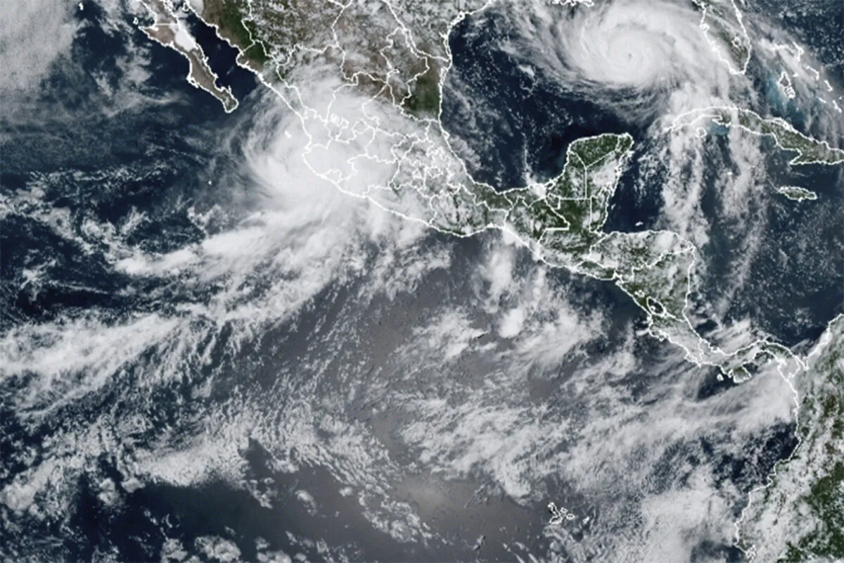 Hurricane Nora (upper left) and Hurricane Ida, (upper right) over the North American continent on Aug. 28, 2021. (NOAA via AP)