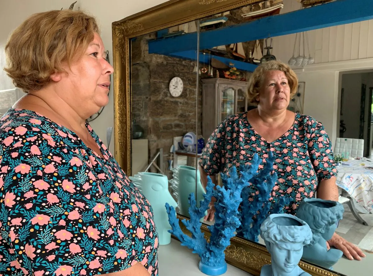 Jeanne Pouchain poses during an interview with Reuters at her home, detailing the ordeal she has been leaving through since being declared dead by a judge, in Saint-Joseph, near Lyon, France, on Aug. 30, 2021. (Cecile Mantovani/Reuters)