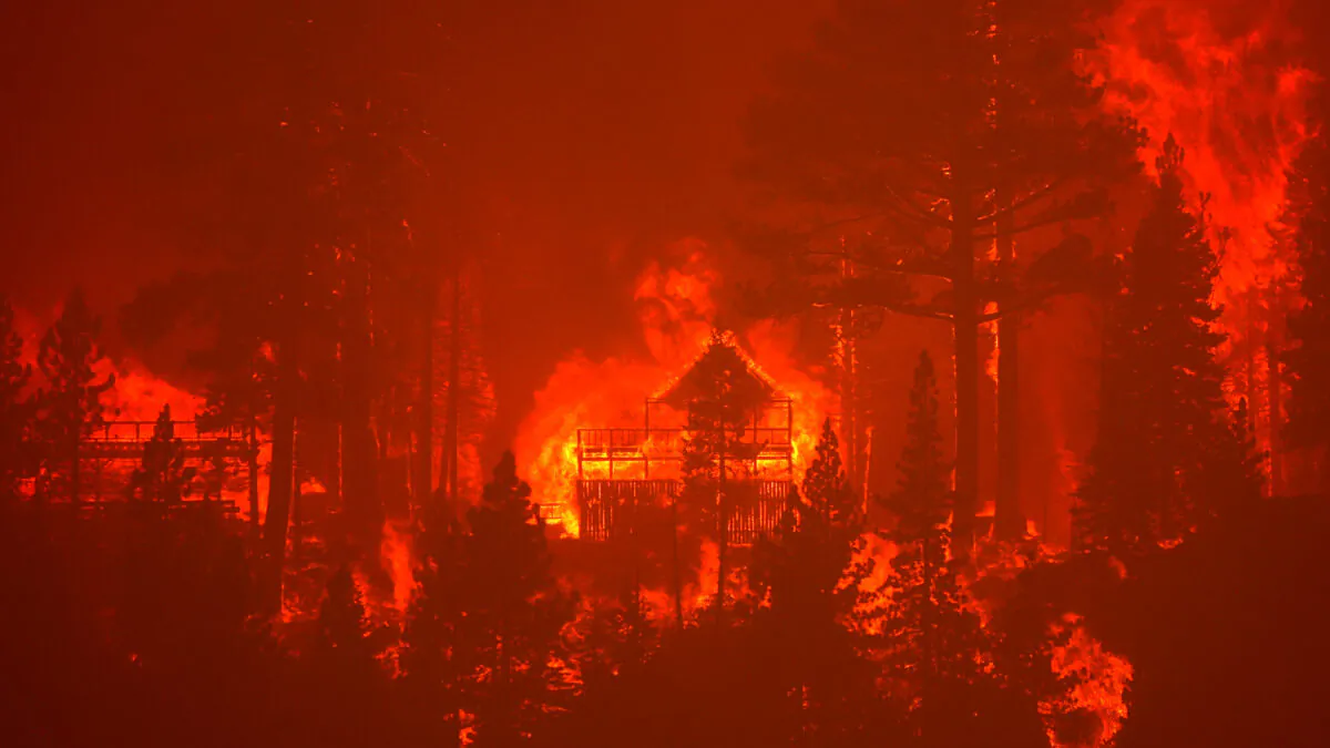 The Caldor Fire burns homes along a ridge on August 30, 2021 near South Lake Tahoe, California.  (Justin Sullivan/Getty Images)
