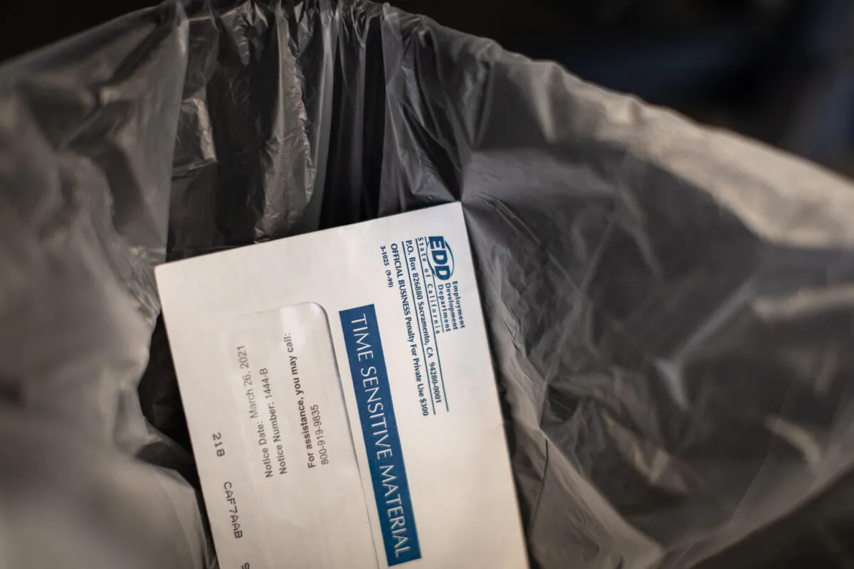 A discarded envelope containing EDD information sits in irvine, Calif., on April 21, 2021. (John Fredricks/The Epoch Times)