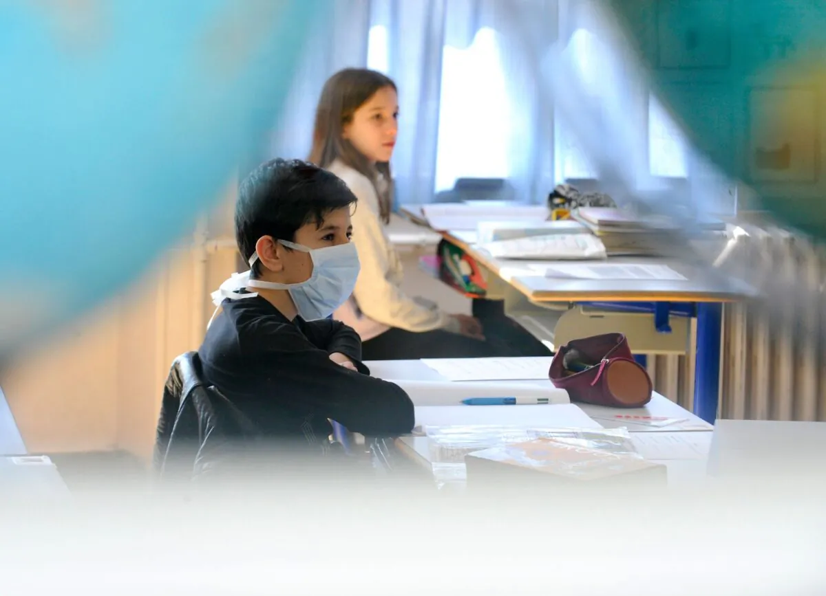 A pupil wearing a face mask attends a class in a file photo. (Jean-Christophe Verhaegen/AFP via Getty Images)