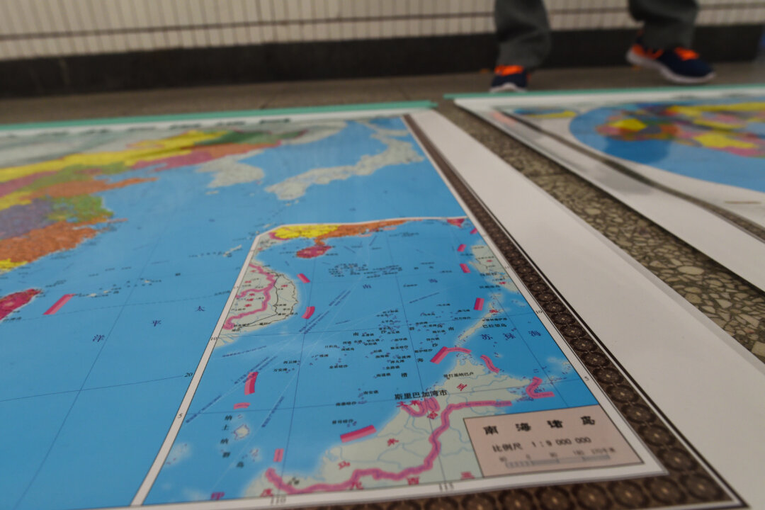 A map designed by China includes an insert with nine-dash lines showing the Chinese regime's claimed territory in the South China Sea in Beijing on June 15, 2016. (Greg Baker/AFP via Getty Images) 