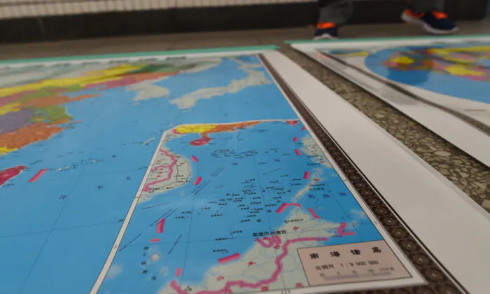 A map designed by China includes an insert with nine-dash lines showing the Chinese regime's claimed territory in the South China Sea in Beijing on June 15, 2016. (Greg Baker/AFP via Getty Images) 