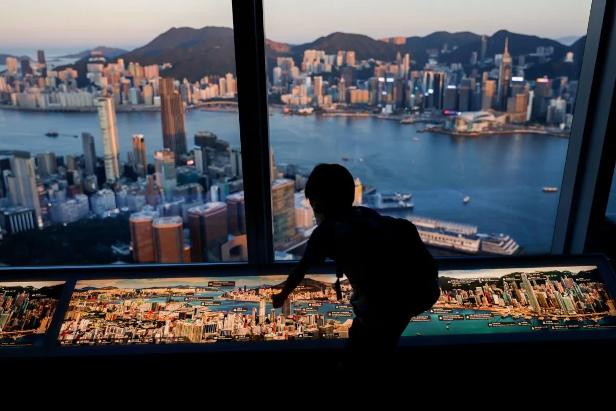 A child in front of skyline buildings, in Hong Kong, on July 13, 2021. (Tyrone Siu/Reuters)