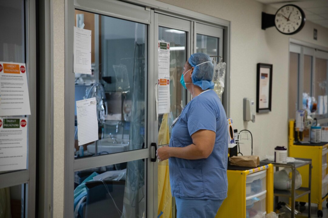 A health care professional prepares to enter a patient's room in this file photo. (Megan Jelinger/AFP via Getty Images) 