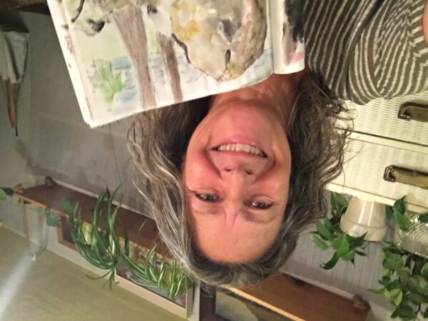 Paula Lynam shows a page from the nature journal she takes her while camping in Washington, Oregon, and California
