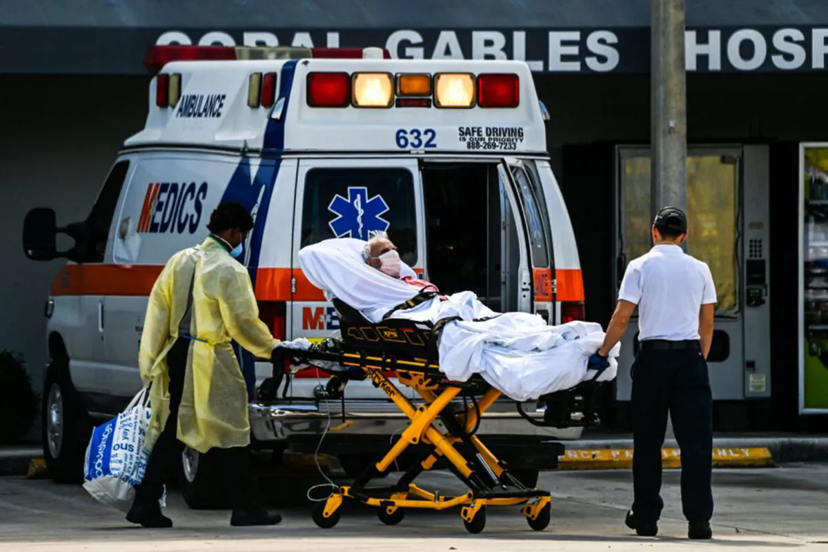 Medics transfer a patient on a stretcher from an ambulance outside of Emergency at Coral Gables Hospital where coronavirus patients are treated in Coral Gables near Miami, Fla., on Aug. 16, 2021. (Chandan Khanna/AFP via Getty Images)