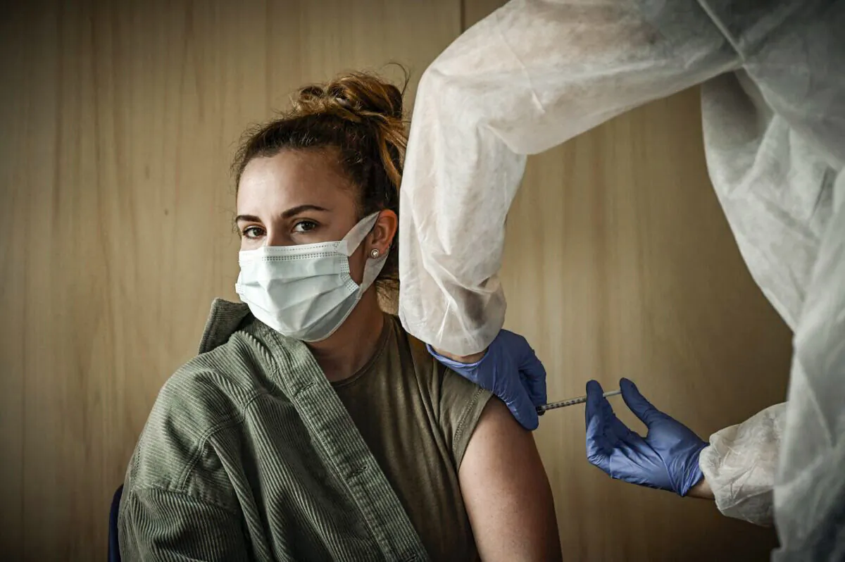 A medical worker vaccinates a patient in a file photo. (Philippe Lopez/AFP via Getty Images)