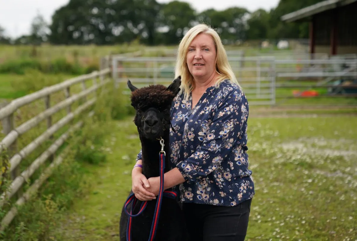 Geronimo the alpaca, with his owner Helen, in this undated picture from a farm near Wickwar, South Gloucestershire, England. (PA) 