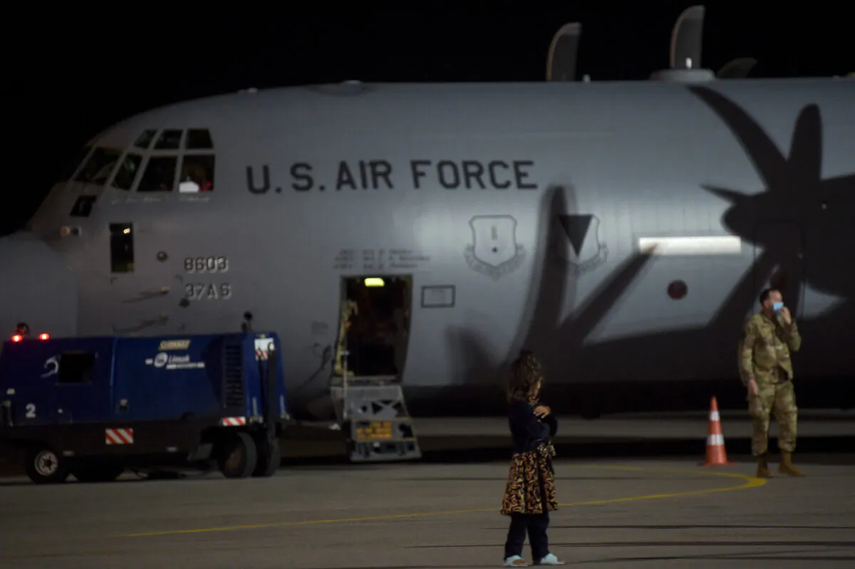 An Afghan refugee girl, fleeing the Afghan capital Kabul, stands on the tarmac after disembarking from an US air force plane upon their arrival at Pristina International airport near Pristina on Aug. 29, 2021. (Armend Nimani/AFP via Getty Images)