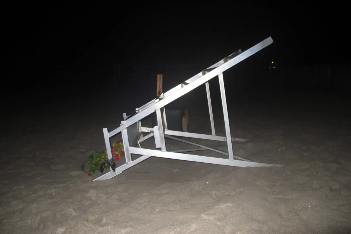 A lifeguard chair sits overturned on the sand at the beach where a young lifeguard was killed and seven others injured by a lightning strike in Berkeley Township, N.J., on Aug. 30, 2021. (Wayne Parry/AP Photo)