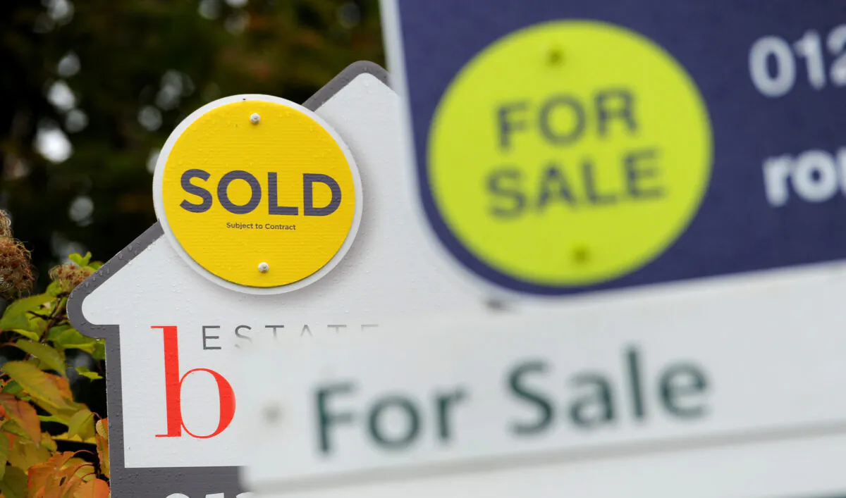 Signs of sold and for sale in an undated file photo, on Oct 14, 2014. (Andrew Matthews/PA)