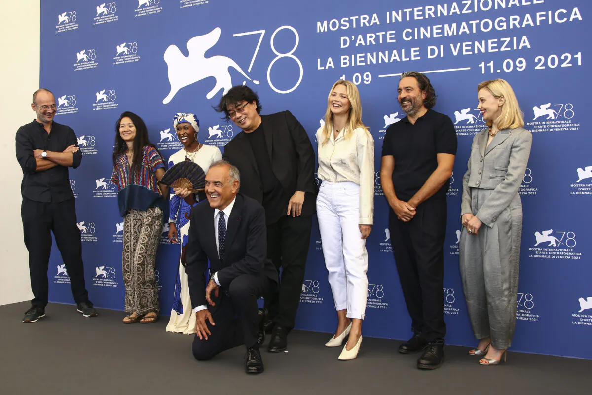Jury members Alexander Nanau, from left, Chloe Zhao, Cynthia Erivo, Jury president Bong Joon Ho, Virginie Efira, Saverio Costanzo, Sarah Gadon, and director of the Venice Film festival Alberto Barbera, front, pose for photographers at the photo call for the jury during the 78th edition of the Venice Film Festival in Venice, Italy, on Sept. 1, 2021. (Joel C Ryan/Invision/AP)