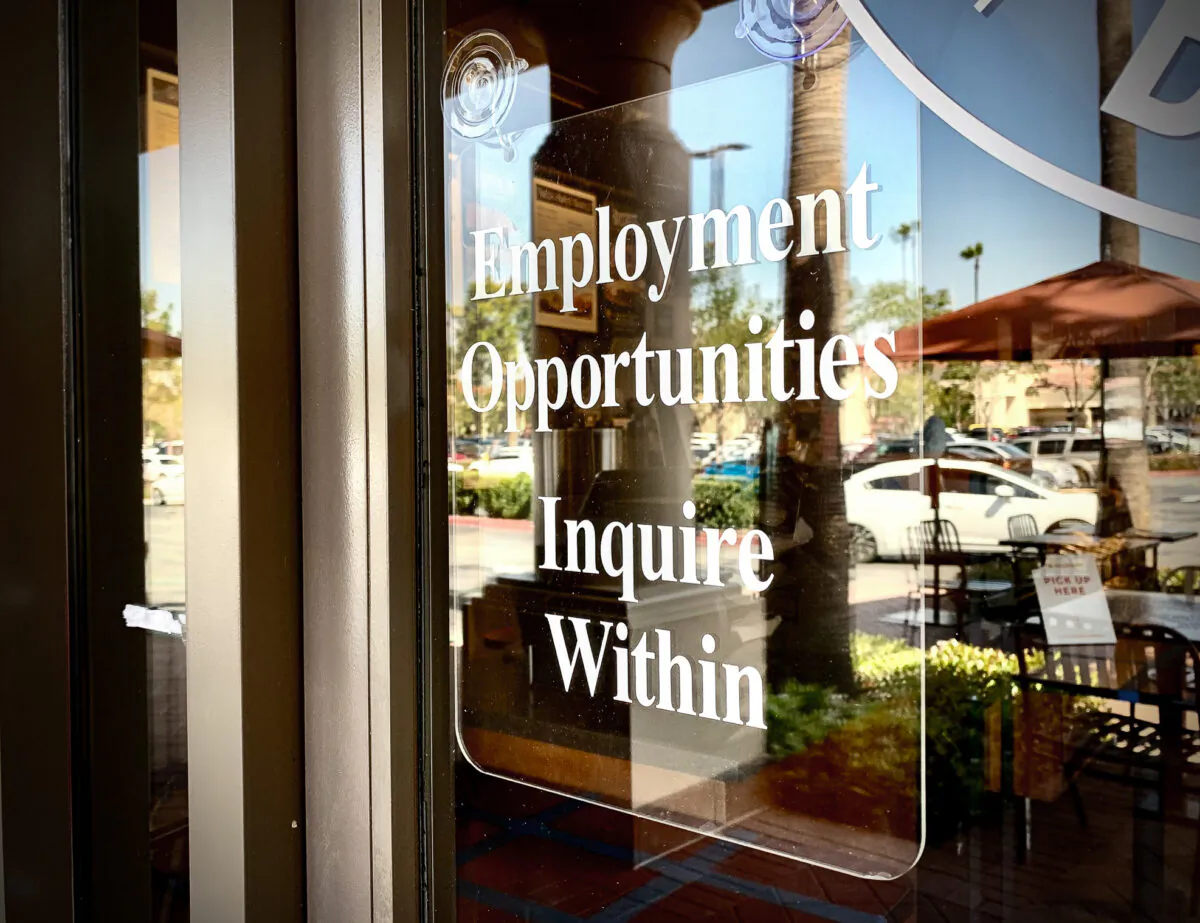 A sign displaying employment opportunities hangs near the doorway of a business in Irvine, Calif., on March 23, 2021. (John Fredricks/The Epoch Times)
