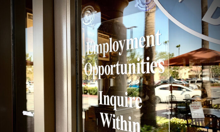 A sign displaying employment opportunities hangs near the doorway of a business in Irvine, Calif., on March 23, 2021. (John Fredricks/The Epoch Times)