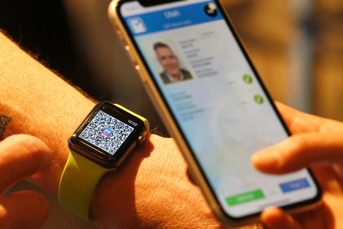 A person scans a QR code on an Apple Watch at a Harmons Grocery store on August 4, 2021 in Salt Lake City, Utah. (George Frey/Getty Images)